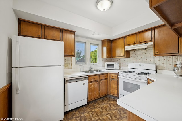 345 Catalpa Ave, Roselle, IL 60172 - kitchen featuring white appliances, under cabinet range hood, brown cabinetry, and decorative backsplash