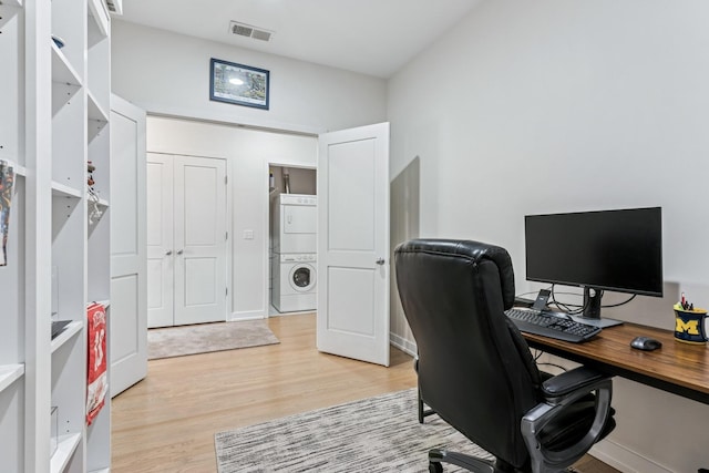 150 W Superior St Unit 1103, Chicago, IL 60654 - office area featuring stacked washer / drying machine and light wood-style floors