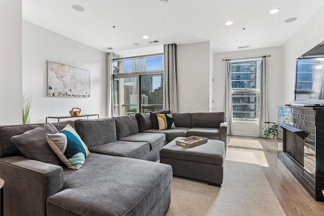 150 W Superior St Unit 1103, Chicago, IL 60654 - living room with recessed lighting, a fireplace, and light wood-type flooring