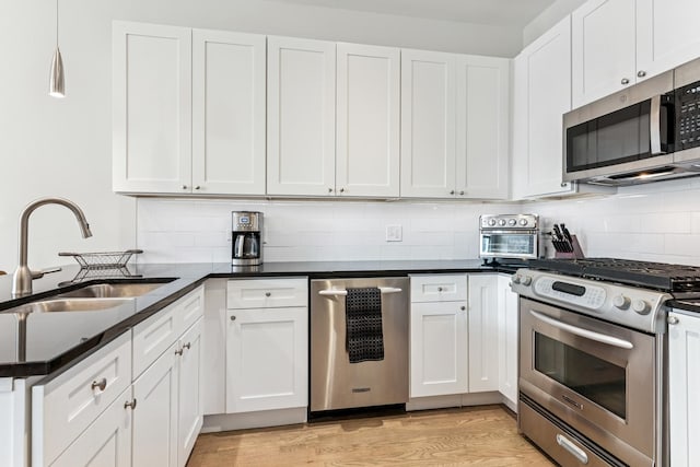 150 W Superior St Unit 1103, Chicago, IL 60654 - kitchen featuring stainless steel appliances, dark countertops, and white cabinets
