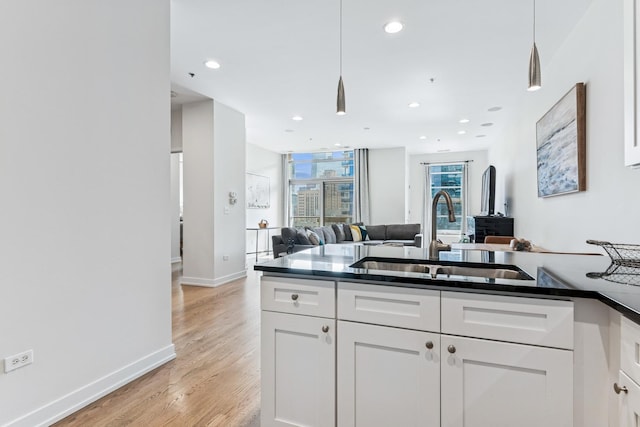 150 W Superior St Unit 1103, Chicago, IL 60654 - kitchen with white cabinets, dark countertops, open floor plan, hanging light fixtures, and recessed lighting