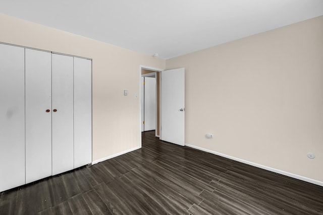 18340 Glen Oak Ave Unit 1D, Lansing, IL 60438 - unfurnished bedroom with dark wood-type flooring and a closet