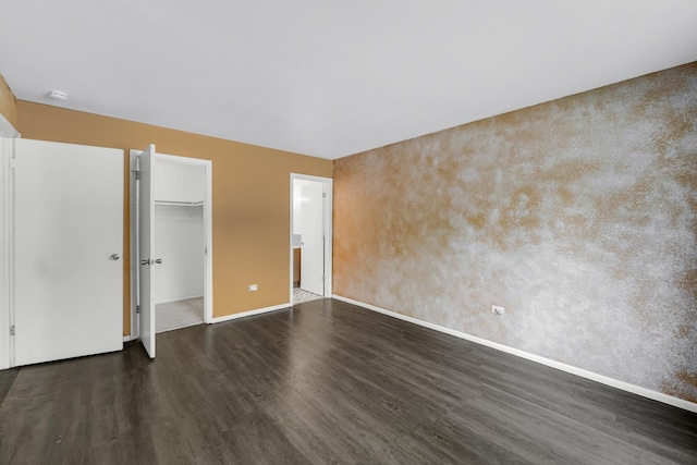 18340 Glen Oak Ave Unit 1D, Lansing, IL 60438 - unfurnished bedroom featuring dark wood-type flooring, a walk in closet, and a closet