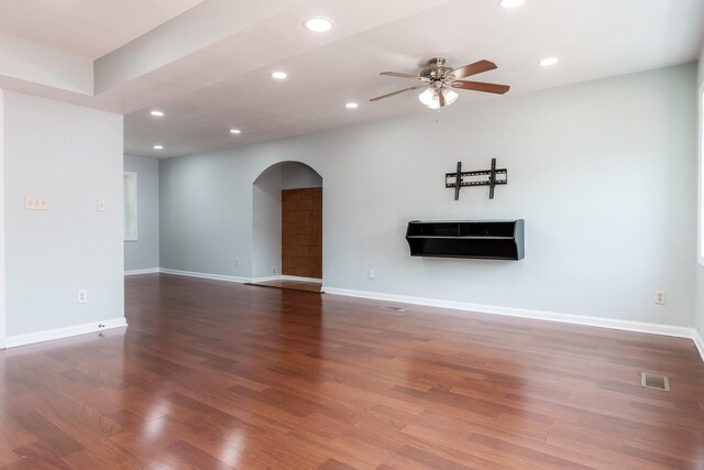 5087 Wilderness Trl, Rockford, IL 61114 - unfurnished living room featuring arched walkways, ceiling fan, wood finished floors, and recessed lighting