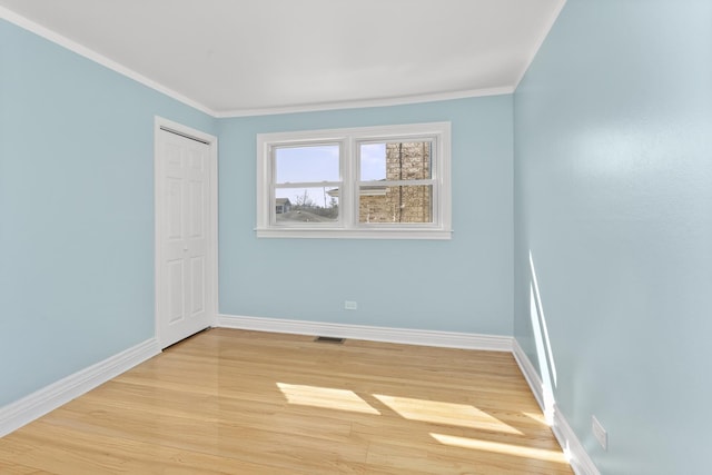 4567 N Merrimac Ave, Chicago, IL 60630 - empty room with light wood-style flooring and crown molding