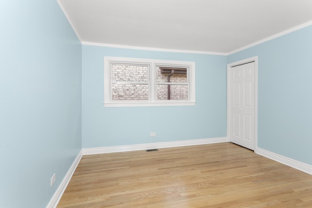 4567 N Merrimac Ave, Chicago, IL 60630 - unfurnished room with crown molding and light wood finished floors