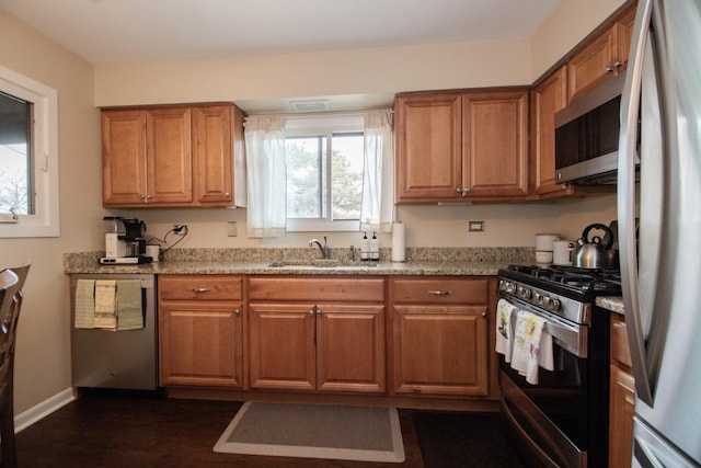 107 65th Lake Dr Unit 202, Westmont, IL 60559 - kitchen featuring appliances with stainless steel finishes, brown cabinets, and dark wood-style flooring