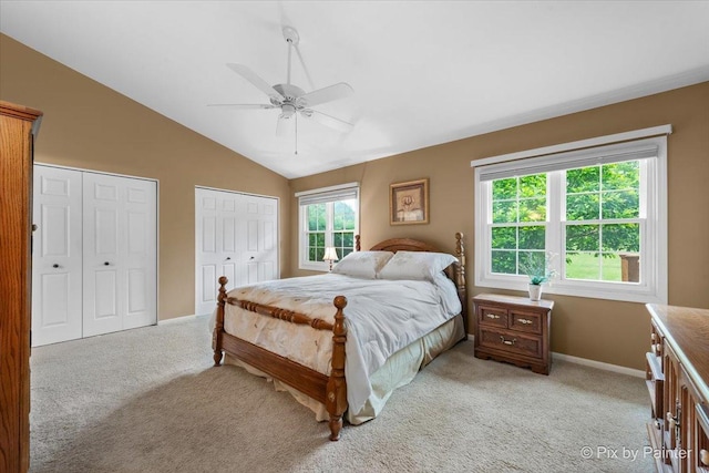 6 Ennis Ct, Cary, IL 60013 - bedroom featuring two closets, light colored carpet, lofted ceiling, and a ceiling fan