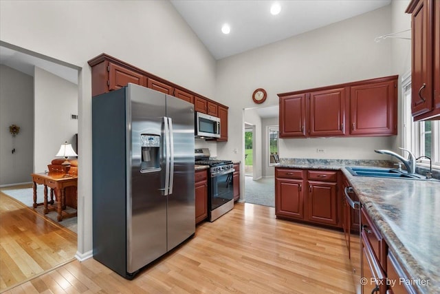 6 Ennis Ct, Cary, IL 60013 - kitchen featuring stainless steel appliances, high vaulted ceiling, light wood-style flooring, plenty of natural light, and recessed lighting