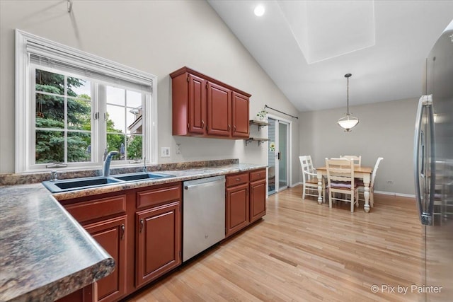6 Ennis Ct, Cary, IL 60013 - kitchen featuring appliances with stainless steel finishes, light wood finished floors, vaulted ceiling, and decorative light fixtures