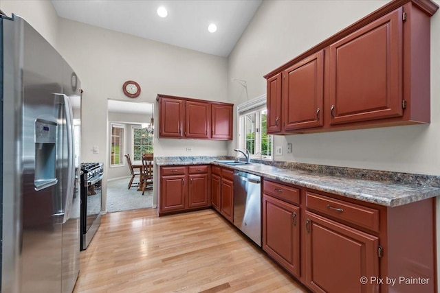 6 Ennis Ct, Cary, IL 60013 - kitchen with stainless steel appliances, light wood finished floors, dark countertops, recessed lighting, and a towering ceiling