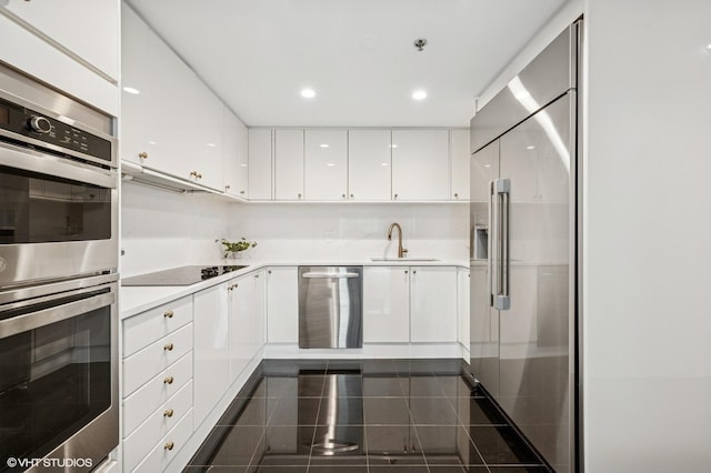100 E Huron St Unit 3501, Chicago, IL 60611 - kitchen featuring stainless steel appliances, white cabinetry, granite floors, recessed lighting, and light countertops