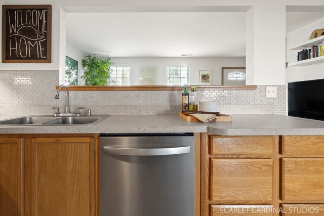 802 Symphony Dr, Aurora, IL 60504 - kitchen with stainless steel dishwasher, tasteful backsplash, light countertops, and brown cabinetry