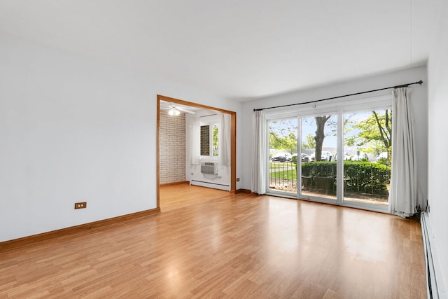 6540 W 94th Pl Unit 1A, Oak Lawn, IL 60453 - unfurnished room featuring a baseboard radiator, plenty of natural light, and light wood-type flooring