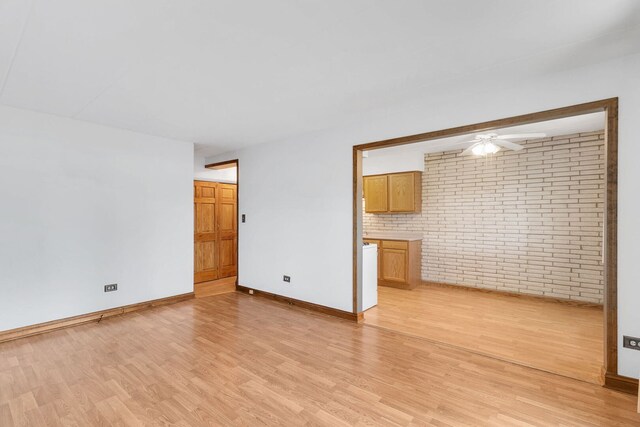 6540 W 94th Pl Unit 1A, Oak Lawn, IL 60453 - unfurnished living room with brick wall, light wood finished floors, and a ceiling fan