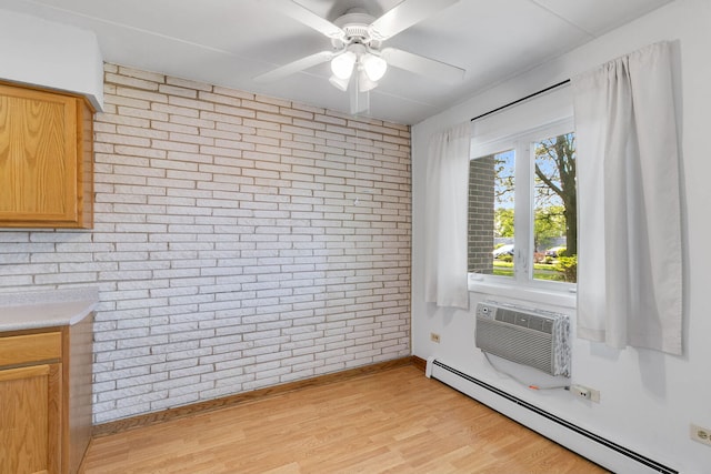 6540 W 94th Pl Unit 1A, Oak Lawn, IL 60453 - unfurnished dining area featuring a baseboard heating unit, brick wall, ceiling fan, light wood finished floors, and a wall mounted AC