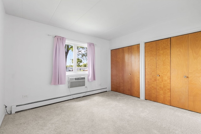 6540 W 94th Pl Unit 1A, Oak Lawn, IL 60453 - unfurnished bedroom featuring a baseboard radiator, a wall unit AC, multiple closets, and carpet