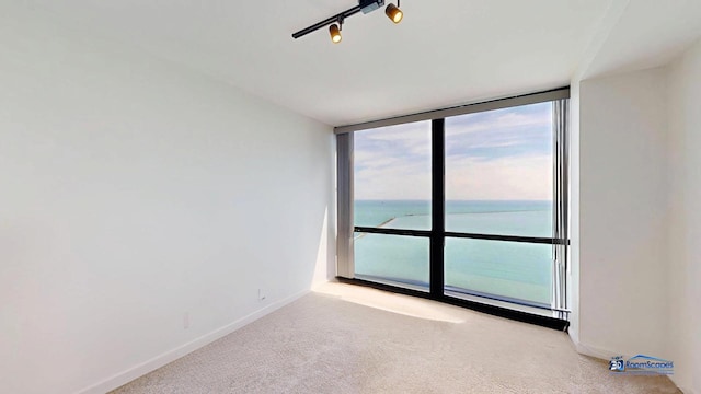 910 N Lake Shore Dr Unit 2317, Chicago, IL 60611 - spare room featuring expansive windows, carpet, and a water view