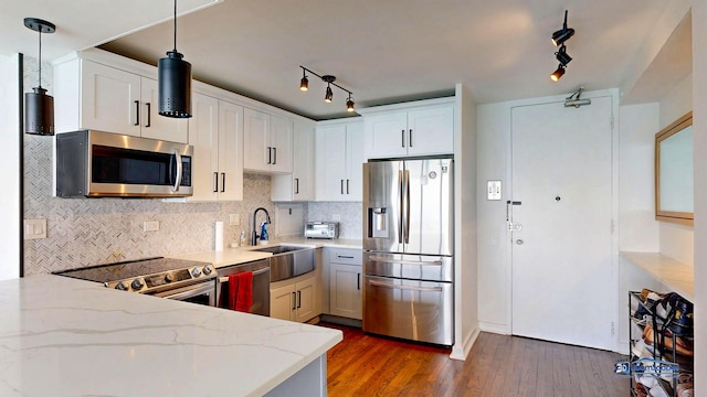 910 N Lake Shore Dr Unit 2317, Chicago, IL 60611 - kitchen featuring appliances with stainless steel finishes, light stone counters, rail lighting, backsplash, and wood finished floors
