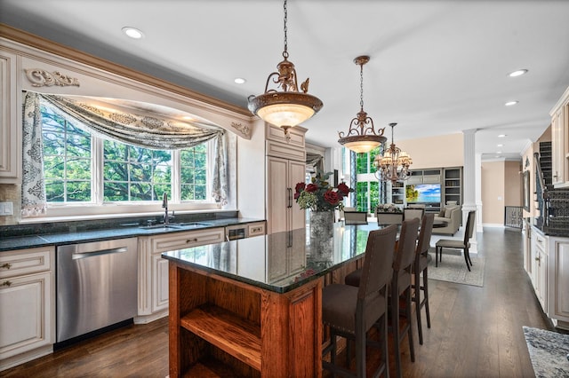 1325 Westley Ln, West Dundee, IL 60118 - kitchen with stainless steel dishwasher, ornate columns, a center island, cream cabinets, and dark wood finished floors