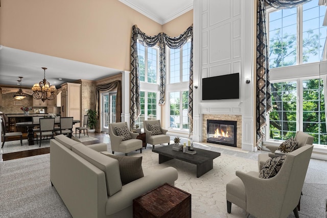1325 Westley Ln, West Dundee, IL 60118 - living room with a towering ceiling, a chandelier, crown molding, and a glass covered fireplace