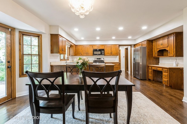 1532 Sequoia Rd, Naperville, IL 60540 - kitchen featuring appliances with stainless steel finishes, brown cabinets, dark wood finished floors, light countertops, and a chandelier