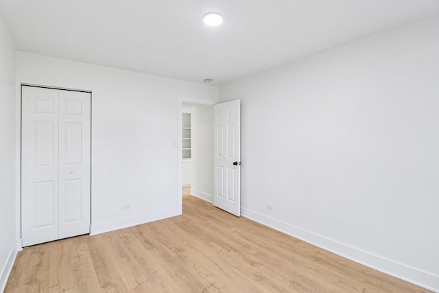 5216 Arlington Cir, Hanover Park, IL 60133 - unfurnished bedroom featuring light wood-style floors and a closet