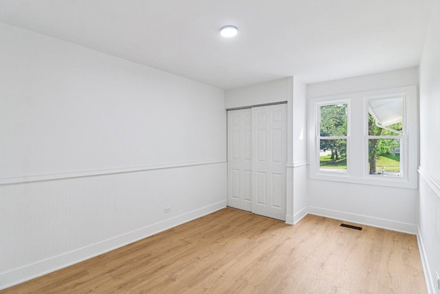 5216 Arlington Cir, Hanover Park, IL 60133 - unfurnished bedroom featuring light wood-style flooring and a closet