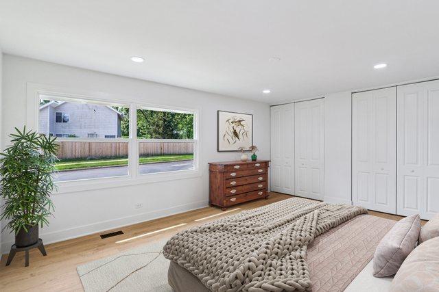 5216 Arlington Cir, Hanover Park, IL 60133 - bedroom featuring multiple closets, wood finished floors, and recessed lighting