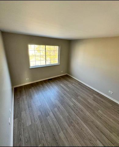 1214 Vista Dr, Gurnee, IL 60031 - unfurnished room featuring dark wood finished floors and baseboards