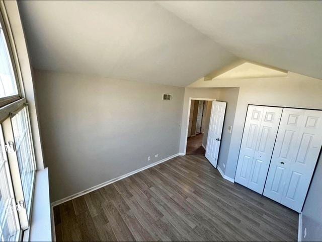 1214 Vista Dr, Gurnee, IL 60031 - unfurnished bedroom with dark wood-style flooring, lofted ceiling, and a closet