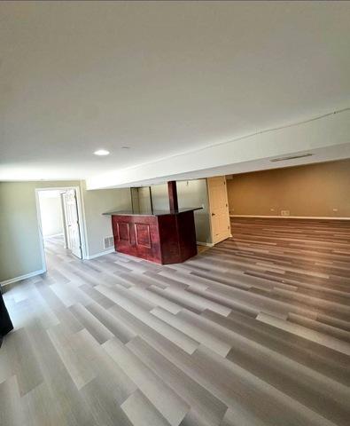 1214 Vista Dr, Gurnee, IL 60031 - unfurnished living room with wood finished floors and baseboards