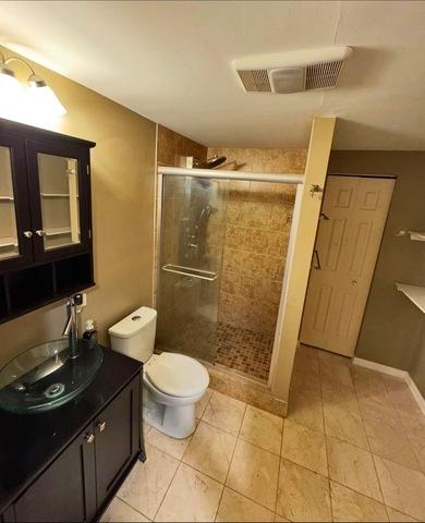 1214 Vista Dr, Gurnee, IL 60031 - bathroom featuring a shower stall, vanity, and tile patterned flooring
