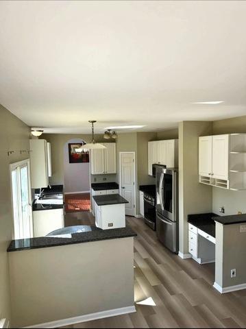 1214 Vista Dr, Gurnee, IL 60031 - kitchen with open shelves, freestanding refrigerator, dark wood finished floors, and a peninsula