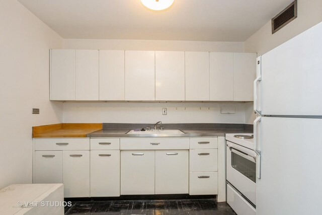 900 N Lake Shore Dr Unit 708, Chicago, IL 60611 - kitchen with white appliances, white cabinetry, and stainless steel countertops