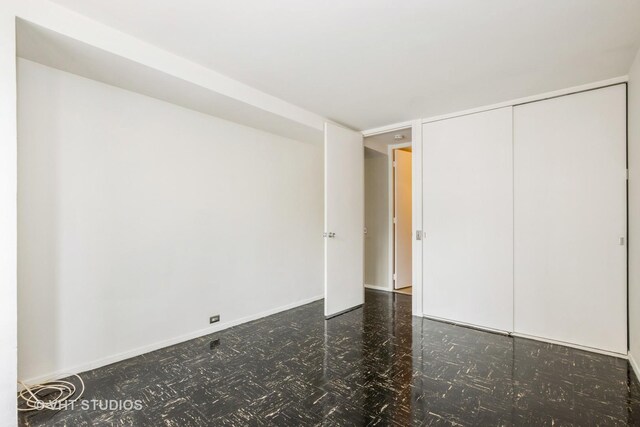 900 N Lake Shore Dr Unit 708, Chicago, IL 60611 - unfurnished bedroom with baseboards and a closet