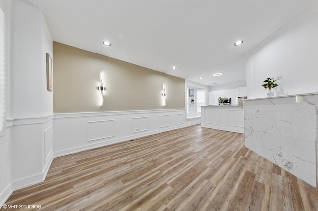 6630 S Drexel Ave, Chicago, IL 60637 - unfurnished living room featuring light wood finished floors, a wainscoted wall, and recessed lighting