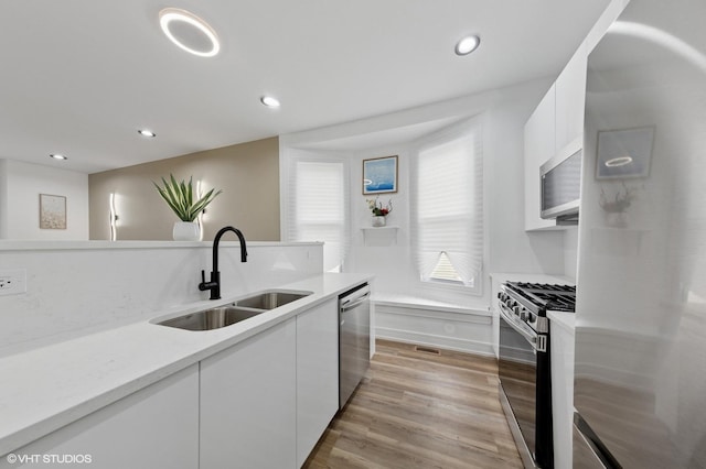 6630 S Drexel Ave, Chicago, IL 60637 - kitchen featuring stainless steel appliances, white cabinetry, modern cabinets, light countertops, and recessed lighting