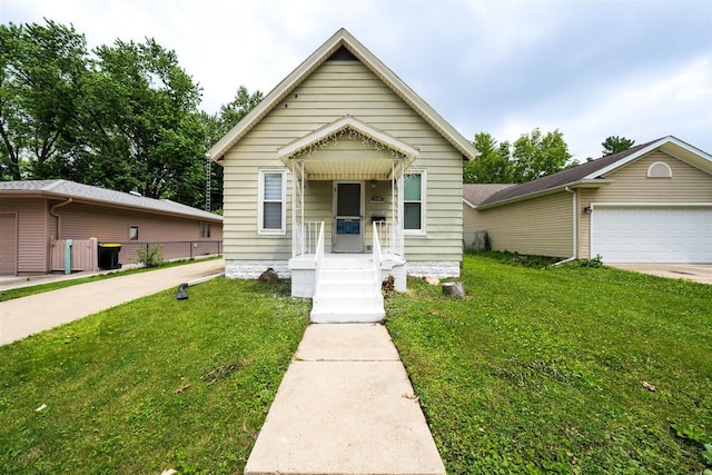 1006 S Adelaide St, Normal, IL 61761 - shotgun-style home with a front lawn and a garage