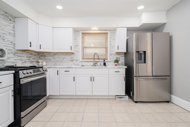 1006 S Adelaide St, Normal, IL 61761 - kitchen with appliances with stainless steel finishes, tasteful backsplash, white cabinets, and recessed lighting