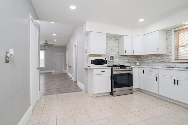 1006 S Adelaide St, Normal, IL 61761 - kitchen featuring stainless steel range oven, white microwave, plenty of natural light, light countertops, and recessed lighting