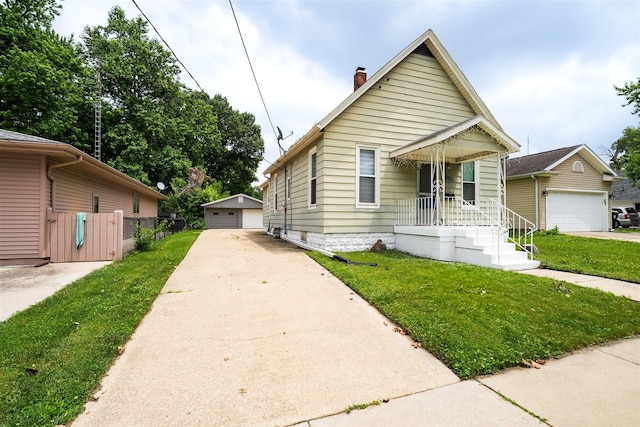 1006 S Adelaide St, Normal, IL 61761 - view of front of property with a front lawn, an outbuilding, a chimney, and a garage