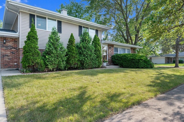 537 W Stearns Rd, Bartlett, IL 60103 - tri-level home with brick siding, a front yard, and a chimney
