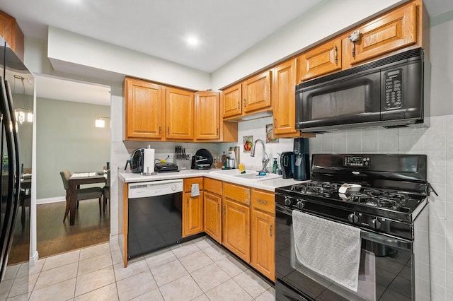 537 W Stearns Rd, Bartlett, IL 60103 - kitchen featuring black appliances, light countertops, light tile patterned floors, brown cabinets, and tasteful backsplash