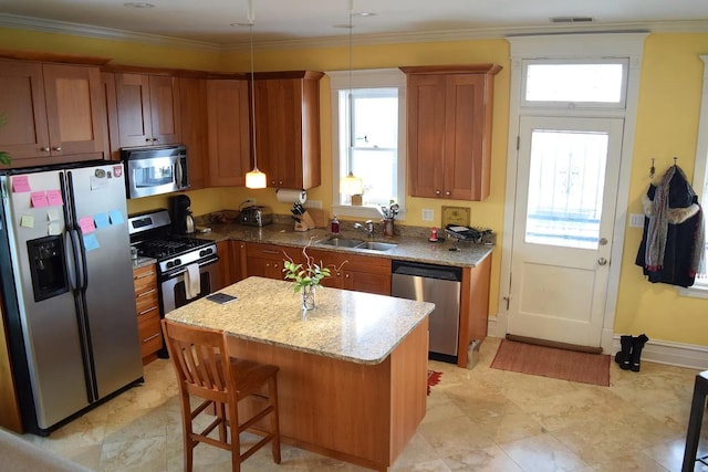 4623 N Beacon St Unit 3N, Chicago, IL 60640 - kitchen featuring stainless steel appliances, brown cabinetry, a kitchen island, light stone countertops, and pendant lighting