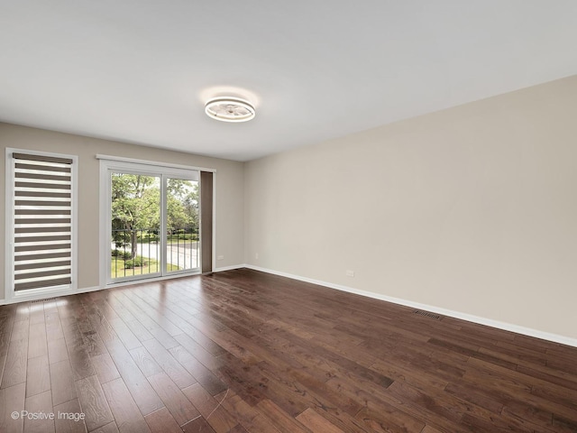2S578 Patrick Henry Sq Unit 578, Oak Brook, IL 60523 - unfurnished room with baseboards and dark wood-type flooring