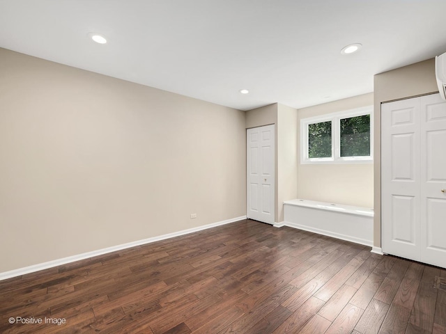 2S578 Patrick Henry Sq Unit 578, Oak Brook, IL 60523 - unfurnished bedroom featuring multiple closets, dark wood-type flooring, and recessed lighting