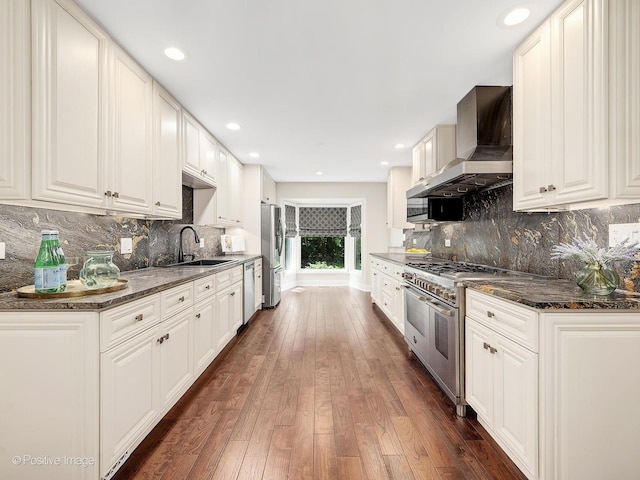 2S578 Patrick Henry Sq Unit 578, Oak Brook, IL 60523 - kitchen with appliances with stainless steel finishes, wall chimney range hood, dark wood-style floors, decorative backsplash, and recessed lighting