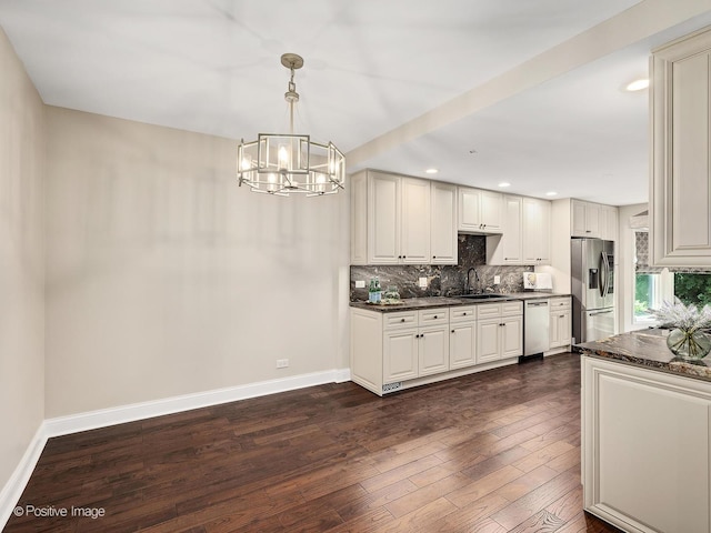 2S578 Patrick Henry Sq Unit 578, Oak Brook, IL 60523 - kitchen with stainless steel appliances, a chandelier, decorative backsplash, dark wood-type flooring, and hanging light fixtures