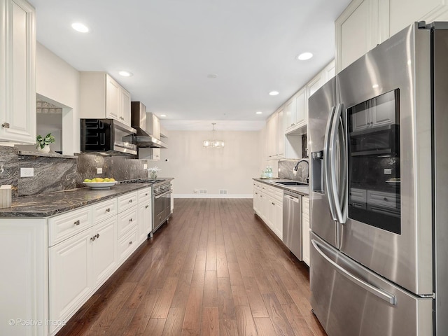2S578 Patrick Henry Sq Unit 578, Oak Brook, IL 60523 - kitchen featuring appliances with stainless steel finishes, wall chimney exhaust hood, backsplash, a chandelier, and dark wood-type flooring